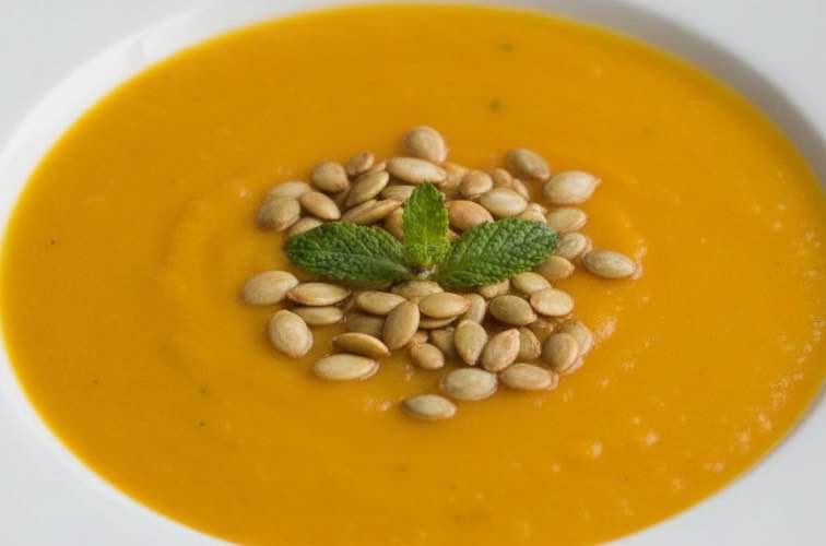 Italienische Kürbissuppe – Cremiger Herbstgenuss aus der Cucina Italiana 4 Italienische Kürbissuppe mit Kürbiskernen serviert